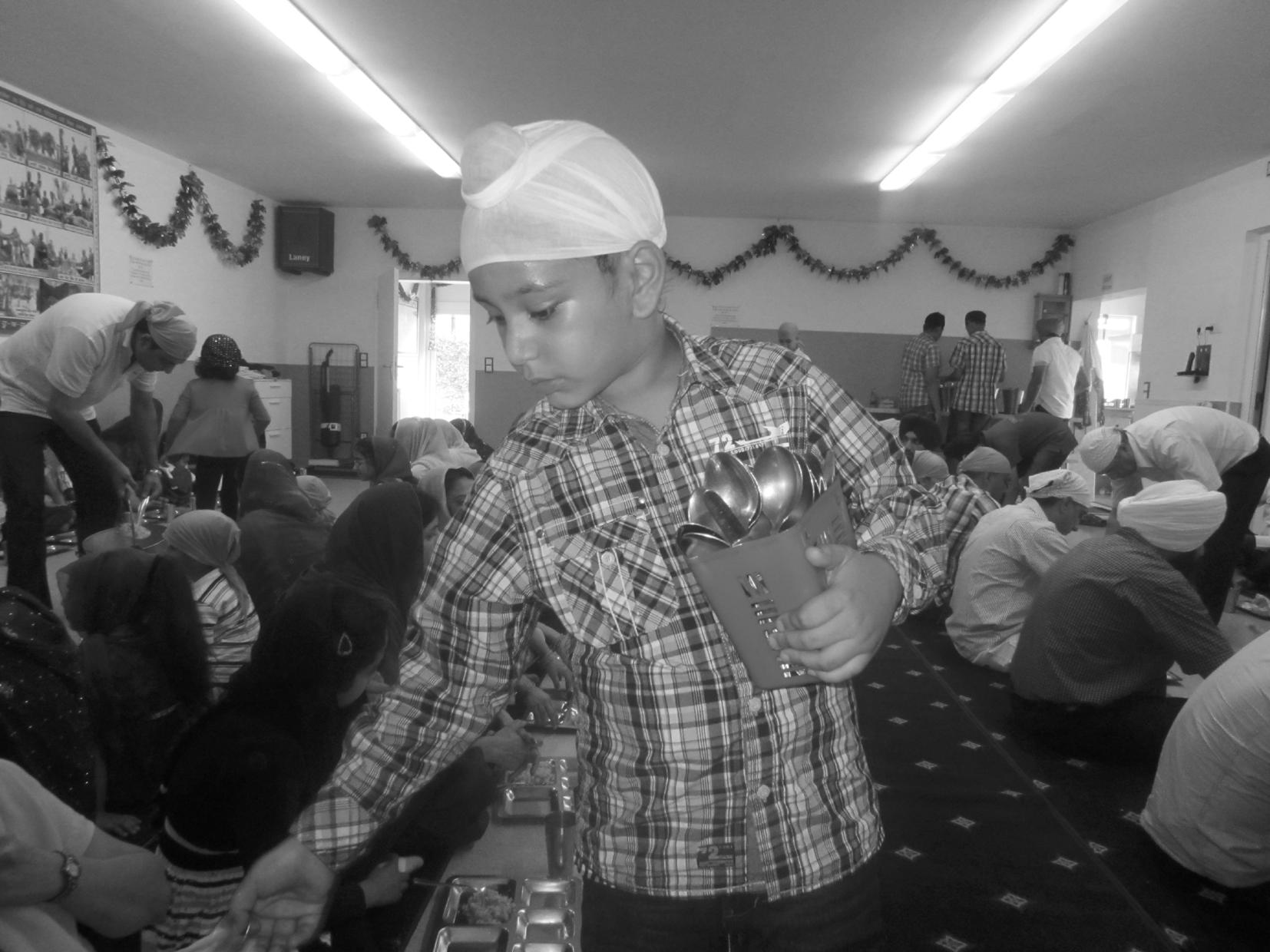 A young child doing 'langar sewa' Essen Gurdwara, Germany